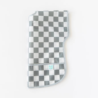Bumkins Junior Bib: Charcoal Check is folded lengthwise on a white background.