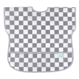 Bumkins Junior Bib: Charcoal Check features gray and white checkered, easy-wipe waterproof fabric, with pocket at the bottom.