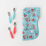 Bumkins Junior Bib: Ariel lays folded next to two sets of utensils in blue and red on a white background.