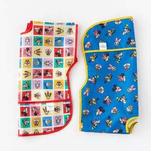 Two Bumkins Junior Bibs featuring Mickey & Friends Excellent Eight, shown on a white background.