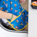 Close-up of a child's hand reaching into the pocket of a bib from Bumkins Junior Bib 2 Pack: Mickey & Friends Excellent Eight.