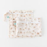 Two bags from Bumkins The Chaos Coordinator Deluxe 5-Piece Set: Palm Daze lay overlapped on a white background.