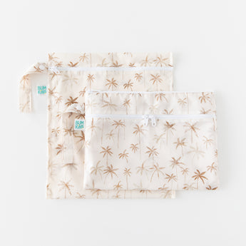 Two bags from Bumkins The Chaos Coordinator Deluxe 5-Piece Set: Palm Daze lay overlapped on a white background.