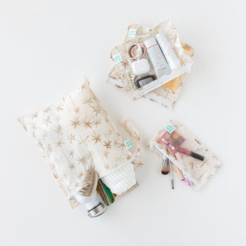 Bumkins The Chaos Coordinator Essential 4-Piece Set: Palm Daze holds makeup, a water bottle, and towel on a white background.