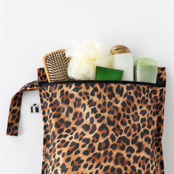 Roamio by Bumkins Wet Bag: Leopard filled with toiletries lays on a white background.