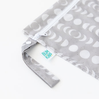 Bumkins Wet Bag + Wet/Dry Bag Set in Lunar Phase—waterproof, reusable, with zipper & snap handle for packing essentials.