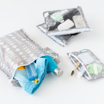 Bumkins The Chaos Coordinator Essential 4-Piece Set: Lunar Phase holds swim gear and toiletries on a white background.