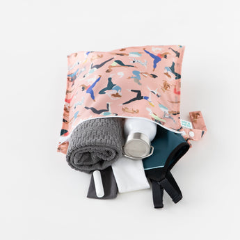 Bumkins Wet Bag: Yoga Pals holds a gray towel, water bottle, gym clothes, and small items effortlessly on a white background.