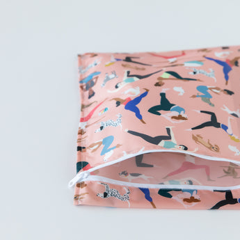 Bumkins Wet Bag: Yoga Pals lays partially open on a white background, revealing the interior.