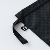Close-up of Roamio by Bumkins Wet Bag: Rich Black on a white background, with focus on the side strap and logo tag.