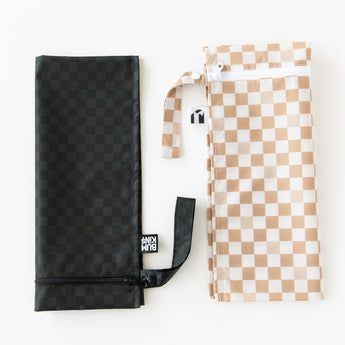 Bumkins Wet Bag 2 Pack: Sand and Black Check lays folded on a white background.