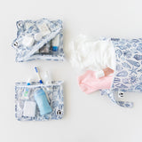 Roamio by Bumkins The Commuter Essential 4-Piece Set: Shells holds clothes and toiletries on a white background.