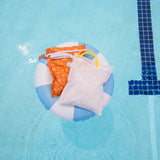 Bumkins Wet Bag 2 Pack: Wander + Grounded lays atop a blue & white striped inner tube in a pool; 2 diving rings peek out of the beige bag.