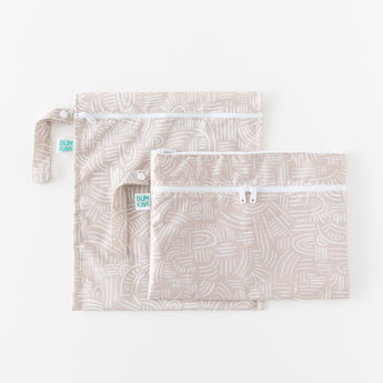 Two bags from Bumkins The Chaos Coordinator Deluxe 5-Piece Set: Wander lay overlapped on a white background.