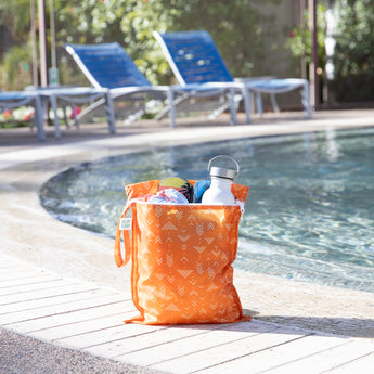 Packing essentials: Bumkins Wet Bag + Wet/Dry Bag Set: Grounded by the pool with a water bottle and towels.