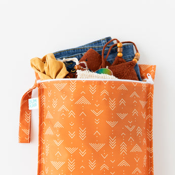 Bumkins Wet Bag: Grounded holds clothes and swimwear on a white background.