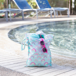 The Bumkins Wet Bag + Wet/Dry Bag Set: Rainbow is a colorful, waterproof essential for your poolside or travel packing.