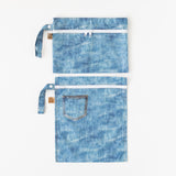 Roamio by Bumkins Wet Bag + Wet/Dry Clutch Set: Denim On Denim is neatly arranged on a white background.