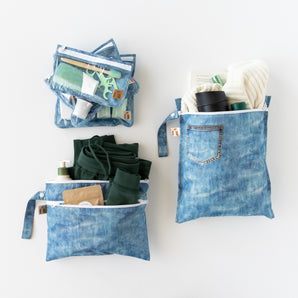 Roamio by Bumkins The Commuter Deluxe 5-Piece Set: Denim On Denim holds travel essentials on a white background.