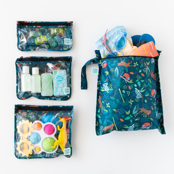Bumkins The Chaos Coordinator Essential 4-Piece Set: Jungle is neatly arranged on a white background, holding swim gear, toiletries, & toys.