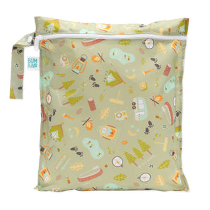 Bumkins Wet Bag: Camp Gear features a camp-themed design with tents and trees on green waterproof fabric and a white zipper.