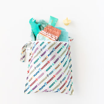 A bag from Bumkins On-The-Go Mealtime 7-Piece Set: Mickey & Friends MVP holds pool essentials on a white background.