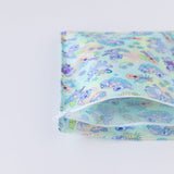 The Bumkins Wet Bag: Aloha Stitch, featuring cartoon illustrations, is partially unzipped on a white background.