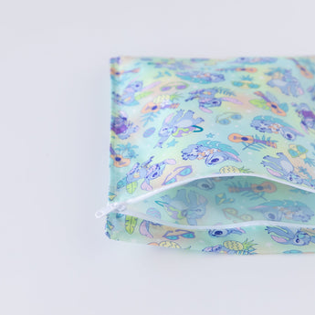 The Bumkins Wet Bag: Aloha Stitch, featuring cartoon illustrations, is partially unzipped on a white background.