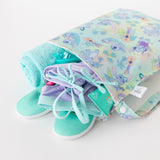 Bumkins Wet Bag + Wet/Dry Bag Set in Aloha Stitch with a towel, turquoise shoes, and swimsuit on a white background.