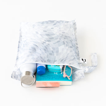The Roamio by Bumkins Wet Bag 2 Pack: Disco Boots holds books, glasses & toiletries. Made of waterproof fabric on white background.