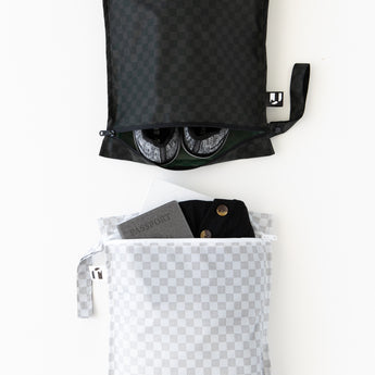 Roamio by Bumkins Wet Bag 2 Pack: Rich & Boujee is neatly arranged on a white background with shoes, clothes, and a passport inside.