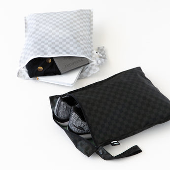 Roamio by Bumkins Wet Bag 2 Pack: Rich & Boujee—grey for essentials, black fits sneakers; both waterproof travel pouches.
