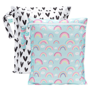Bumkins Wet Bag 2 Pack: Hearts and Rainbows includes 2 zippered waterproof bags—one white with black hearts, one blue with rainbows & clouds.