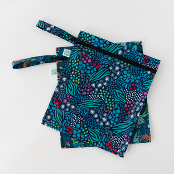 Bumkins Wet Bag 2 Pack: Jungle + Animal Prints lays overlapped on a white background.