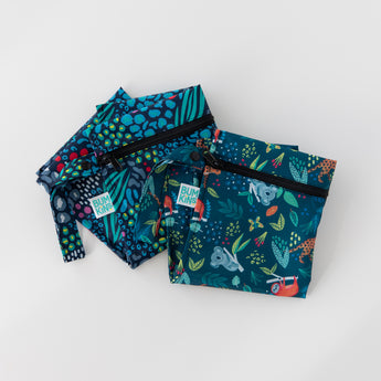 Bumkins Wet Bag 2 Pack: Jungle + Animal Prints sit folded on a white background, partially overlapped.