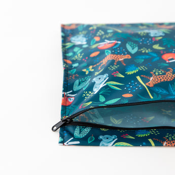 A Bumkins Wet Bag 2 Pack: Jungle + Animal Prints lays partially open on a white background, showcasing the interior.