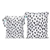 Bumkins Wet Bag + Wet/Dry Bag Set: Hearts features 2 white waterproof bags with black hearts and zipper closure.