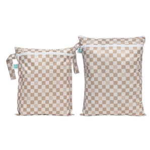 The Bumkins Wet Bag + Wet/Dry Bag Set in Sand Check: stylish beige & white reusable bags—perfect packing essentials.