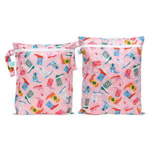 Bumkins Wet Bag + Wet/Dry Bag Set in Boots print: 2 pink zippered bags with cowboy boots/hats pattern and side handles.