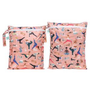 The Bumkins Wet Bag + Wet/Dry Bag Set: Yoga Pals features two pink, eco-friendly, reusable packing bags with playful yoga prints.