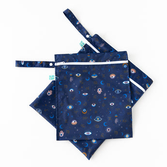 The Bumkins Wet Bag + Wet/Dry Bag Set: Evil Eye features navy bags with mystical eyes—stylish diapering essentials.