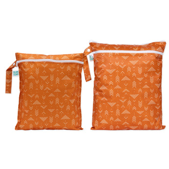 Bumkins Wet Bag + Wet/Dry Bag Set: Grounded—2 orange waterproof bags with white abstract arrow patterns and zipper closures.