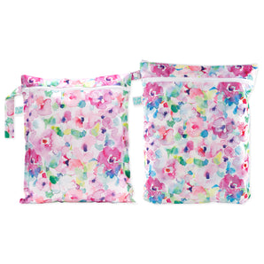 The Bumkins Wet Bag + Wet/Dry Bag Set: Watercolor features two reusable pouches with pink, purple, and green floral patterns.