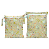 Bumkins Wet Bag + Wet/Dry Bag Set: Camp Gear—2 green waterproof bags with camping-themed illustrations and zipper closures.