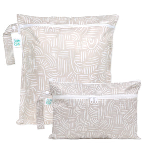 Bumkins Wet Bag + Wet/Dry Clutch Set: Wander—two beige waterproof bags with white abstract lines; one large, one small, both zippered.