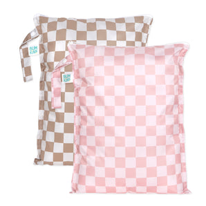 Bumkins Wet Bag Plus 2 Pack: Mauve + Sand Check includes 2 waterproof checkered bags in tan and pink with zipper closures and side handles.
