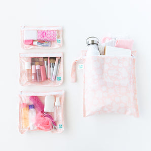 Bumkins The Chaos Coordinator Essential 4-Piece Set: Lace holds toiletries, makeup, clothes, & a water bottle on a white background.