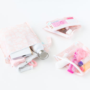 Bumkins The Chaos Coordinator Essential 4-Piece Set: Lace holds toiletries, a water bottle, & clothes on a white background.