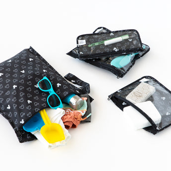 Bumkins The Chaos Coordinator Essential 4-Piece Set: Mickey Mouse Icon Black + White holds beach gear and toiletries on a white background.