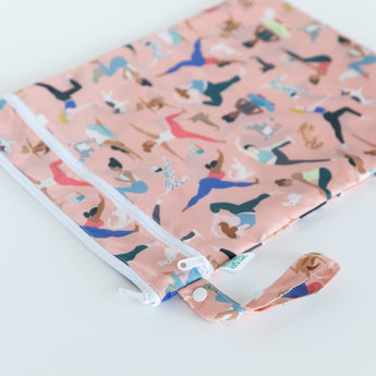 Bumkins Wet/Dry Bag: Yoga Pals rests on a white background with the loop handle angled toward the camera.